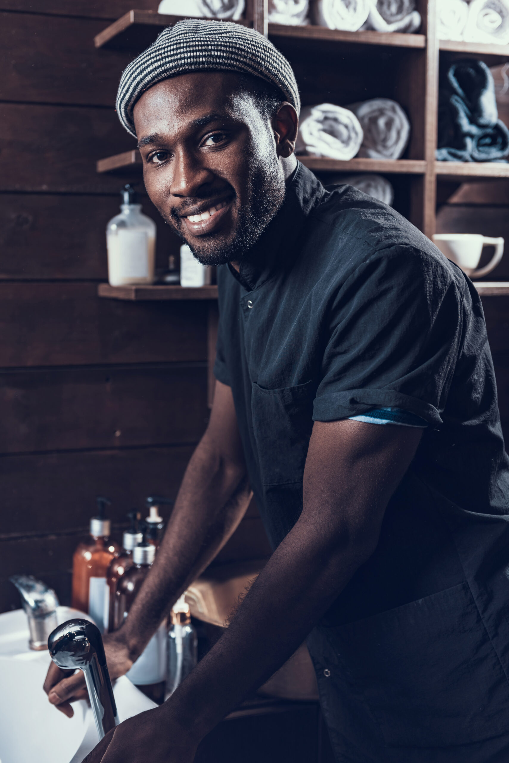 Hairstylist standing in salon and smiling nice